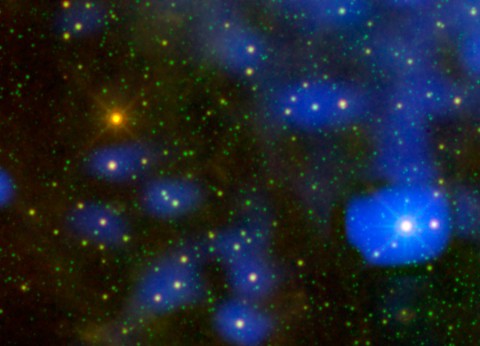 It's a dust bunny of cosmic proportions. Astronomers used images from NASA's Wide-field Infrared Survey Explorer, or WISE, to locate an aging star shedding loads of dust (orange dot at upper left). Only one other star, called Sakurai's object, has been caught erupting with such large amounts of dust. The process is a natural part of aging for stars like our sun. As they puff up into red giants, they shed dust that is later recycled back into other stars, planets, and in the case of our solar system, living creatures. (Image credit: NASA/JPL-Caltech)