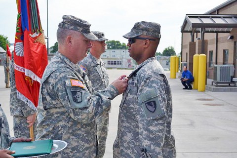 1st Class Alondo Brown receives the Purple Heart from 101st Sustainment Brigade Commander, Col. Michael Peterman, at a special ceremony May 21st, 2012. Brown received the award for injuries he sustained in combat during Operation Iraqi Freedom, in 2006. (U.S. Army photo by Sgt. 1st Class Pete Mayes.)