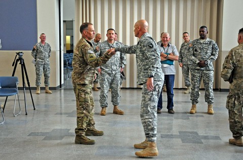 Col. Dan Walrath, commander, 2nd Brigade Combat Team, 101st Airborne Division (Air Assault), shakes hands with Command Sgt. Maj. Scott Schroeder, the highest ranking senior enlisted of the 101st Abn. Div., at Fort Campbell’s flight line, moments before Strike’s departure for eastern Afghanistan, Apr. 27th. The 101st’s Strike Brigade is sending advisory teams for the Afghan National Security Forces in support of Operation Enduring Freedom. (U.S. Army photo by Sgt. Joe Padula, 2nd BCT PAO, 101st Abn. Div.)