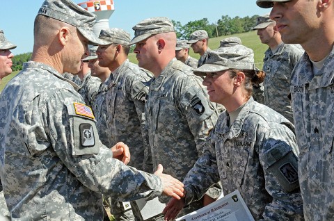 Col. Steven Drennan, commander of the 86th Combat Support Hospital, awards an Expert Field Medical Badge to Sgt. Rachel Barrett, a health care specialist with the 2nd Battalion, 44th Air Defense Artillery Regiment and a native of Murfreesboro, TN, May 11th, 2012 at Fort Campbell, KY. (U.S. Army photo by 101st Sustainment Brigade Public Affairs.)