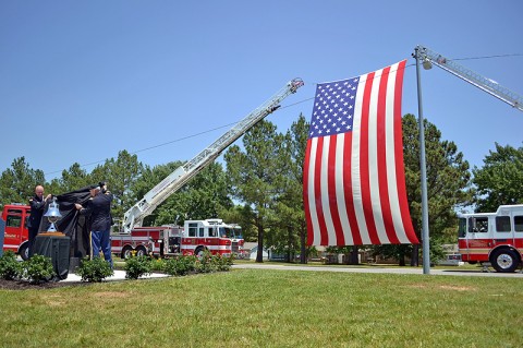 Fort Campbell Fire and Emergency Services Chief Kevin Baylor and Fort Campbell Garrison Commander Col. Perry C. Clark unveil a 9/11 monument in front of Fire Station 1. (U.S. Army photo by Nondice Thurman, Fort Campbell Public Affairs.)