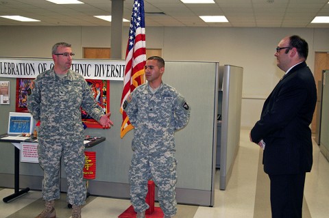 Blanchfield Army Community Hospital's Deputy Commander for Administration Col. Alejandro Lopez-Duke speaks on behalf of Sgt. Jean C. Herazo today during a Naturalization Ceremony where Herazo was sworn in as a U.S. Citizen. The ceremony was held at the Warrior Transition Battalion complex. 