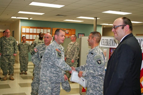 Warrior Transition Battalion commander Lt. Col. William Howard congratulates Sgt. Jean C. Herazo after Herazo was sworn in as a U.S. Citizen, the Naturalization Ceremony was held at the Warrior Transition Battalion May 18th. 