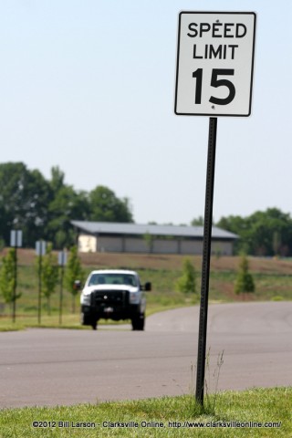 The sign says 15mph, and they are watching The sign says 15mph, and they are watching