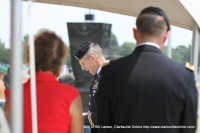 Chaplain Paul Hurley gives the invocation as Maj. Gen. James C. McConnell and his wife looks on