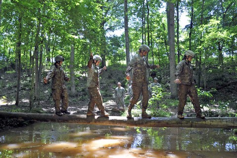 Lady Night Stalkers from 2nd Battalion, 160th Special Operations Aviation Regiment (Airborne) cross the balance beam over the water pit during the Pink Platoon event May 9th at Fort Campbell, KY. (160th Special Operation Aviation Regiment  (Airborne) photo)