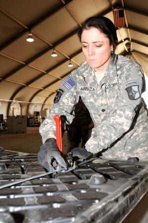 Spc. Sirlen Arriaza, non-rolling stock clerk, 227th Quartermaster Company, from Indianapolis, Ind., secures a pallet of equipment with metal binding strips at the redistribution property assistance team yard on Contingency Operating Base Adder, Nov. 27. (Spc. Anthony Zane/U.S. Army) Spc. Sirlen Arriaza, non-rolling stock clerk, 227th Quartermaster Company, from Indianapolis, Ind., secures a pallet of equipment with metal binding strips at the redistribution property assistance team yard on Contingency Operating Base Adder, Nov. 27. (Spc. Anthony Zane/U.S. Army)