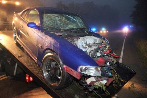 The Ford Mustang after it was pulled out of the embankment and loaded onto a tow truck. (Photo by CPD-Jim Knoll)