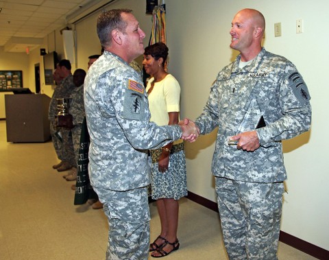 Chief Warrant Officer 4 Jonathan Pace, Battalion Warrant Officer for 2nd Battalion, 5th Special Forces Group (Airborne), is congratulated by Command Sgt. Maj. William Zaiser, Command Sergeant Major for the U.S. Army Special Forces Command, after being presented the U.S. Army Special Operations Command Additional Duty Safety Officer of the Year Award from Brig. Gen. Edward M. Reeder, Jr., Commanding General, U.S. Army Special Forces Command, during a ceremony June 26th, 2012, at the 5th SFG (A) headquarters. (Photo by Sgt. Kerry Otjen)