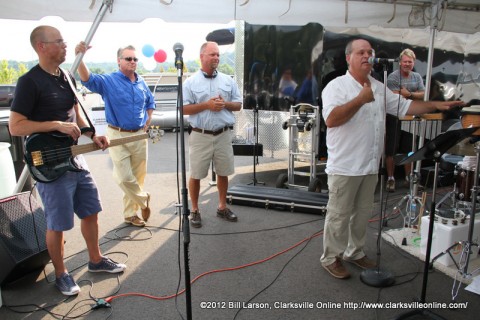 Clarksville Marina general manager Dave signs, addresses the crowd as Ron Cheney (Light Blue Shirt) and Darby Campbell (Dark Blue Shirt) look on