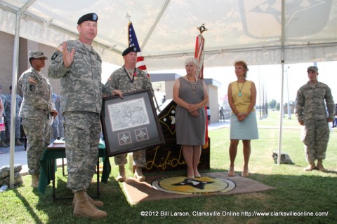 Maj. Gen. James C. McConville, Commander of the 101st Airborne Division (Air Assault) praises Col. Michael P. Peterman and his wife Kathy