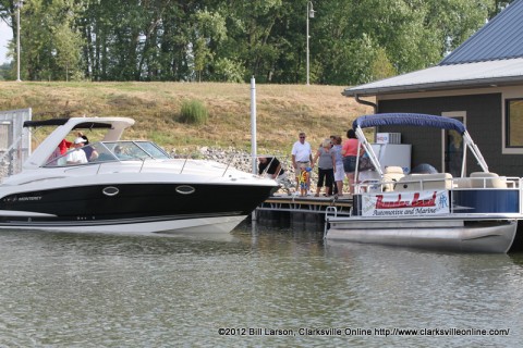 Bill Roberts of the Roberts Thunderbird Automotive and Marine stands on the dock between two of his boats