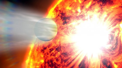 This artist's rendering illustrates the evaporation of HD 189733b's atmosphere in response to a powerful eruption from its host star. NASA's Hubble Space Telescope detected the escaping gases and NASA's Swift satellite caught the stellar flare. (Credit: NASA's Goddard Space Flight Center)