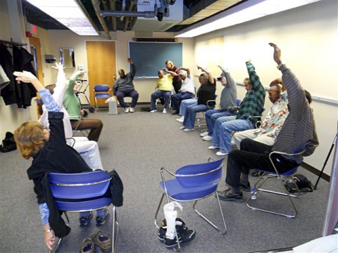 Stroke survivors in modified half moon yoga pose. (Courtesy Roudebush Veterans Administration-Medical Center and Indiana University)