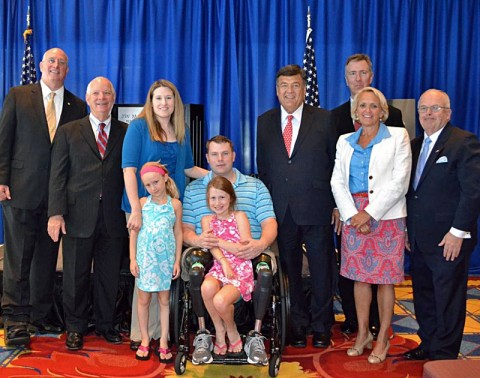 (left to right): David Coker, President Fisher House Foundation; Senator Ben Cardin; Jessica Allen and her husband; Staff Sgt. Charles "Chaz" Allen, US Army and their daughters, Ryann and Deryn Allen; Congressman Dutch Ruppersberger; Mark Nicpon, VP of Marketing, Distribution and CIO, AmericInn; Debbie Marriott Harrison, Senior VP of Government Affairs, Marriott; Joseph A. McInerney, president and chief executive officer of American Hotel & Lodging Association.