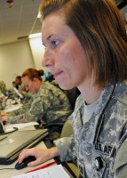 Capt. Jillian Cavanaugh of the III Corps Staff Judge Advocate Office, monitors her work station during the corps’ Warfighter Exercise at Fort Hood, Texas, June 15th, 2012. Cavanaugh is one of more than 5,500 service members participating in the training event, which is slated to conclude June 22nd. (Photo Credit: Dave Larsen, III Corps Public Affairs)