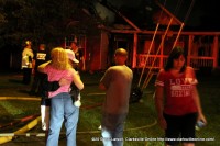 Jeff and Kathy Sale comfort each other in front of their burned out home