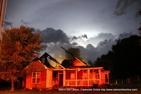 A burst of lighting provides a backlight to the remains of the home