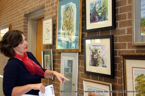 Michelle Dickerson, Planters Bank Vice President of Marketing points out her favorite works by Lynne Griffey