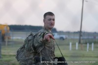 A soldier points at a family member as he passes on his way to the Personnel Processing Center