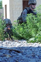 Spc. Matthew Parr (right) and Pvt. Mathew Goff, 3rd Special Troops Battalion Soldiers pulling security, assume a security posture during a training air assault exercise at Fort Campbell, Ky., Aug. 8. The air assault exercise is part of 3rd STBs Soldiers preparation for deployment to Afghanistan. (U.S. Army photo by Sgt. Shanika L. Futrell, 159th Combat Aviation Brigade Public Affairs)