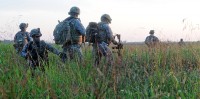 A Soldier from 3rd Special Troops Battalion, 3rd Brigade Combat Team watches insurgents while his team continues to search the rest of the village during an air assault training exercise at Fort Campbell, Ky., Aug. 8. 3rd STB Soldiers conducted a mission-essential task list air assault training to hone on its Soldiers skills prior to their deployment to Afghanistan. (U.S. Army photo by Sgt. Shanika L. Futrell, 159th Combat Aviation Brigade Public Affairs)