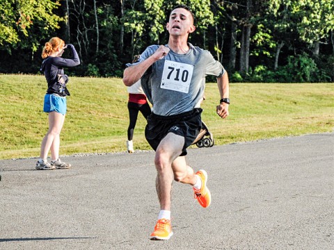 Spc. Logan Donahue, an infantryman with 1st Battalion, 502nd Infantry Regiment, 2nd Brigade Combat Team, 101st Airborne Division (Air Assault), sprints his way to the finish line during a 10-kilometer race at Fort Campbell’s Sabalauski Air Assault School, Aug. 12th. The race was a part of The Week of the Eagles 2012, competition promoting unit cohesion throughout the division. (US Army Photo by Pfc. Jasmine Aguilar, 2nd BCT PAO, 101st ABN.DIV.)