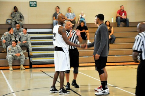 Soldiers from 101st Airborne Division (Air Assault), shake hands prior to the tip off on August 13. The basketball game was held at Lozada Gym as part of Week of the Eagles. (U.S. Army photo by Spc. Paul Russ, 2nd BCT PAO, 101st ABN. DIV.)