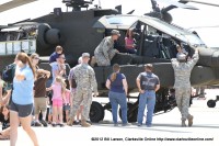 A young girl gets a moment in the pilots seat in a Boeing AH-64 Apache helicopter A young girl gets a moment in the pilots seat in a Boeing AH-64 Apache helicopter
