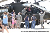 A young girl gets a moment in the pilots seat in a Boeing AH-64 Apache helicopter