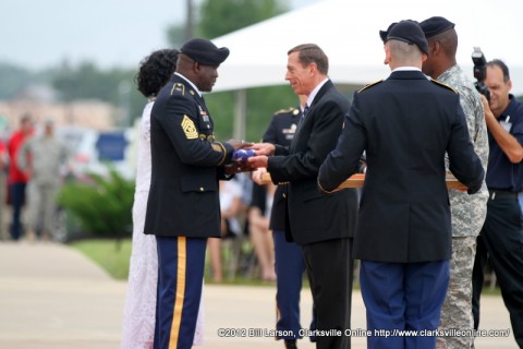 Gen. David H. Petraeus (U.S. Army Ret) presents a flag that flew over the 101st Airborne Division headquarters to Command Sergeant Major Marvin L. Hill  at his retirement ceremony