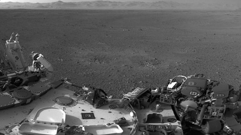 This mosaic image shows part of the left side of NASA's Curiosity rover and two blast marks from the descent stage's rocket engines. (Image credit: NASA/JPL-Caltech)