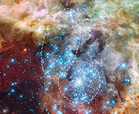 This is a Hubble Space Telescope image of a pair of star clusters that are believed to be in the early stages of merging. The clusters lie in the gigantic 30 Doradus nebula, which is 170,000 light-years from Earth. The Hubble observations, made with the Wide Field Camera 3, were taken Oct. 20-27, 2009. The blue color is light from the hottest, most massive stars; the green from the glow of oxygen; and the red from fluorescing hydrogen. (Image Credit: NASA, ESA, R. O'Connell (University of Virginia), and the Wide Field Camera 3 Science Oversight Committee)