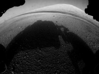 This image shows one of the first views from NASA’s Curiosity rover, which landed on Mars the evening of Aug. 5 PDT (early morning hours Aug. 6 EDT). It was taken through a “fisheye” wide-angle lens on one of the rover’s Hazard-Avoidance cameras. These engineering cameras are located at the rover’s base. As planned, the early images are lower resolution. Larger color images are expected later in the week when the rover’s mast, carrying high-resolution cameras, is deployed. (Image credit: NASA/JPL-Caltech)