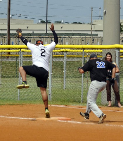 Spc. Gerald Castro, a fire direction center soldier with Company B, 1st Battalion, 320th Field Artillery, 2nd Brigade Combat Team, 101st Airborne Division, lands on 1st Base just in time to tag out the runner from 4th BCT, 101st Abn. Div. Aug. 15 at North Sports Complex here. The softball game was the Championship Match for the Week of the Eagles 2012 Softball Tournament and was won by 2nd BCT. (Photo by Sgt. Jon Heinrich)