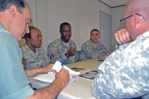 Spc. Patrick Tercius (center), a help desk specialist with Headquarters and Headquarters Company, 159th Combat Aviation Brigade, shares his perceptions of an image displayed during a Stigma Reduction Communications Campaign workshop Tuesday at Fort Campbell, Ky. The SRCC’s goal is to produce an over-arching message to address Soldiers with serious personal issues that perceived stigmas are not a barrier to seek help. (Photo by Jennifer Andersson)