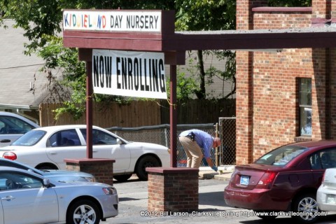 Clarksville Police Department Detective Dave Bramel gathers evidence at Kiddieland Day Nursery on Chapel Street after the shooting.