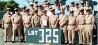 The crew of the LST-325 gathers for a group photograph prior to leaving Crete. (Photo by Joe Milakovich)  Front row, from left: George White*, Clayton (Bill) Nickerson, Donald Molzahn, Ronald Maranto (deceased), James Edwards, Dewey Taylor, Robert Jornlin, Hichael Nedeff, John Calvin and Bailey Wrinkle.   Middle row, from left: Harold Slemmons (deceased), Norval Jones (deceased), Albert White (deceased), Ernest Andrus*, James McCandrew, Joe Sadlier (deceased), Raymond Mai*, Richard Young*, Richard Meyer Crossand Jack Carter Cross.  Back row, from left: Donald Chapman, Edward Strobel, Gary Lyon, Lauren Whiting, Bruce Voges and Corbin Fowkes.   Not pictured: James Bartlett, William Hill, Donald Lockas, Joe Milakovich (deceased), Dominick Perruso and Paul Stimpson Cross.  *Had to depart the ship prior to arrival in Alabama.