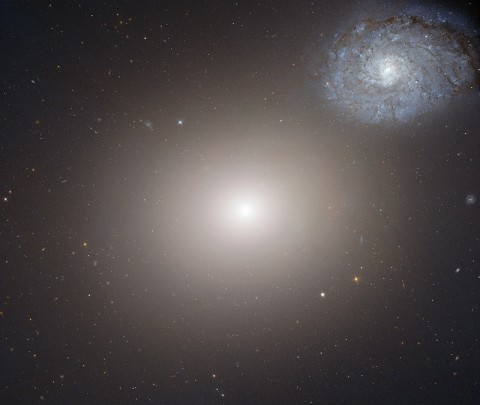 The galaxy pair Arp 116. The faint bluish spiral galaxy NGC 4647 is much lower in mass and about two thirds the size of Messier 60, which occupies the center of this image. NGC4647 is roughly the size of our galaxy, the Milky Way. (Credit: NASA/ESA)