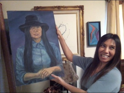 Tess Lankovich displays a realistic painting of herself Tess Lankovich displays a realistic painting of herself