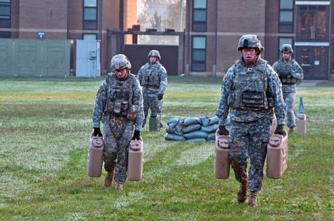 Spc. Michael Burghardt and Staff Sgt. Jason Lines of Headquarters and Headquarters Company, 2nd Brigade Combat Team, 101st Airborne Division (Air Assault), carry full 5 gallon water jugs for 300-meters, Oct. 4 at Fort Campbell’s Strike Field during the Strike Brigade’s combat focused physical training competition called the Iron Strike Challenge. The challenge is designed to push participants to their physical limits while promoting team and unit cohesion. (U.S. Army photo by Sgt. Mike Monroe, 2nd BCT PAO, 101st Abn. Div.)