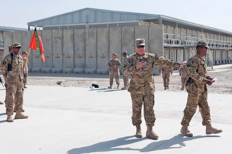 U.S. Army Command Sgt. Maj. Marion E. Arnett, command sergeant major TF Troubleshooter, prevents the escape of Lt. Col. Benjamin S. Bahoque, commander TF Troubleshooter, order for the task force to wish the commander a happy birthday after a combat patch ceremony at Bagram Airfield, Afghanistan on Sept. 22, 2012. (U.S. Army photo by Sgt. Duncan Brennan 101st CAB PAO)