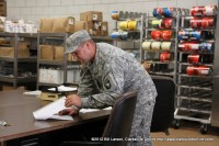 Spc. Burley assists the Rations NCOIC in the Dry Goods Storage