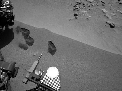 Three bite marks left in the Martian ground by the scoop on the robotic arm of NASA's Mars rover Curiosity are visible in this image taken by the rover's right Navigation Camera during the mission's 69th Martian day, or sol (October 15th, 2012). (Image credit: NASA/JPL-Caltech)