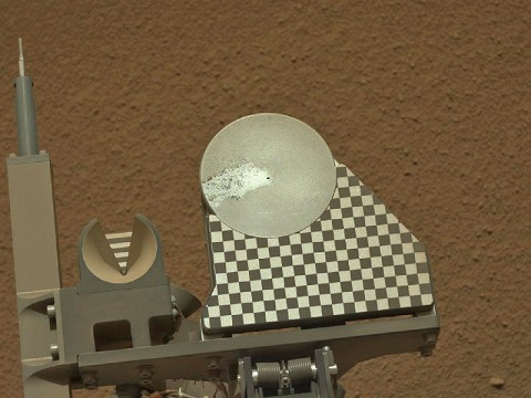 The robotic arm on NASA's Mars rover Curiosity delivered a sample of Martian soil to the rover's observation tray for the first time during the mission's 70th Martian day, or sol (October 16th, 2012). (Image credit: NASA/JPL-Caltech/MSSS)