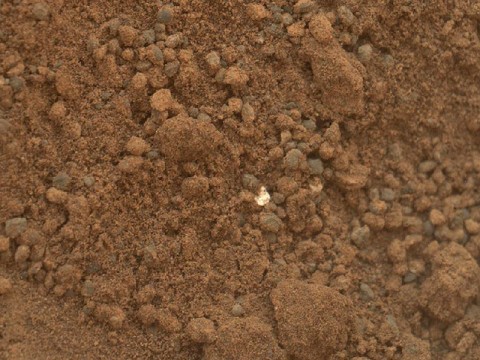 This image shows part of the small pit or bite created when NASA's Mars rover Curiosity collected its second scoop of Martian soil at a sandy patch called "Rocknest." (Image credit: NASA/JPL-Caltech/MSSS)