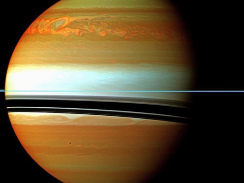 These red, orange and green clouds (false color) in Saturn's northern hemisphere indicate the tail end of a massive storm that started in December 2010. Even after visible signs of the storm started to fade, infrared measurements continued to reveal powerful effects at work in Saturn's stratosphere. (Image credit:NASA/JPL-Caltech/Space Science Institute)