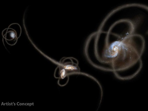 New research from scientists using NASA's Spitzer Space Telescope suggests that a mysterious infrared glow across our whole sky is coming from stray stars torn from galaxies. When galaxies grow, they merge and become gravitationally tangled in a violent process that results in streams of stars being ripped away from the galaxies. Such streams, called tidal tails, can be seen in this artist's concept. Scientists say that Spitzer is picking up the collective glow of stars such as these, which linger in the spaces between galaxies. (Image credit: NASA/JPL-Caltech/UC Irvine)