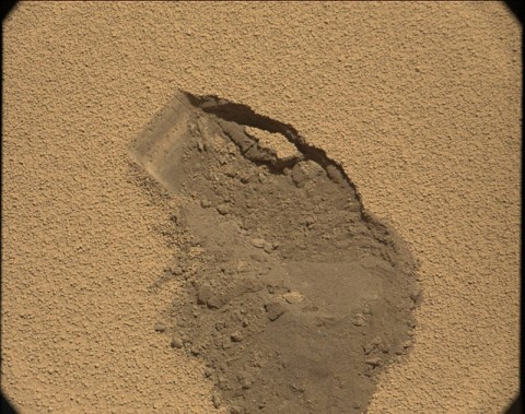 Sol 61 raw image from the right Mast Camera shows the location from which Curiosity's first scoop of soil was collected.  (Image Credit: NASA/JPL-Caltech/MSSS)