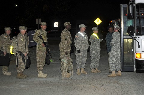 Soldiers from 1st Brigade Combat Team, 101st Airborne Division, climb onto buses Oct. 29 in front of brigade headquarters here to be taken to the airfield terminal to deploy to Afghanistan. (Photo by Sgt. Jon Heinrich)